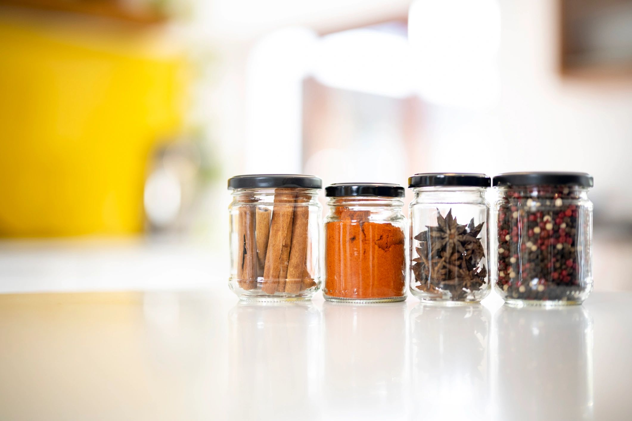 Spice jars arranged on a kitchen counter