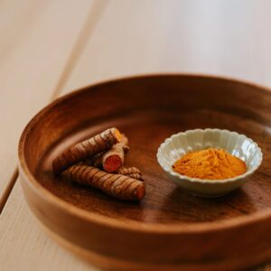 Empire Masale Turmeric Powder 200g pouch with bowl of turmeric powder on neutral background