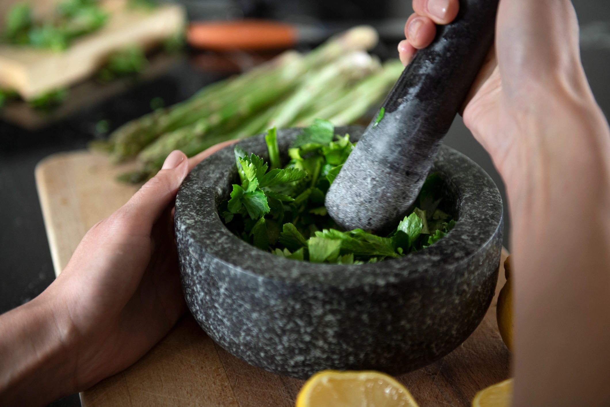 Hands grinding spices with a mortar and pestle